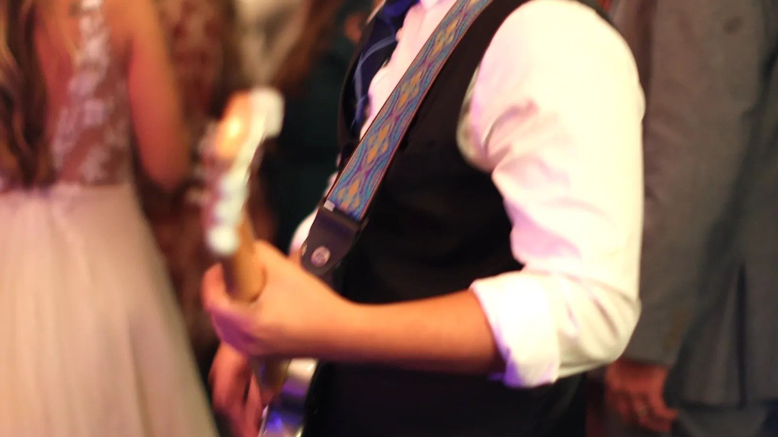 Mixmode's live electric guitarist playing beside the bride's gown on the dance floor at a 2023 wedding reception