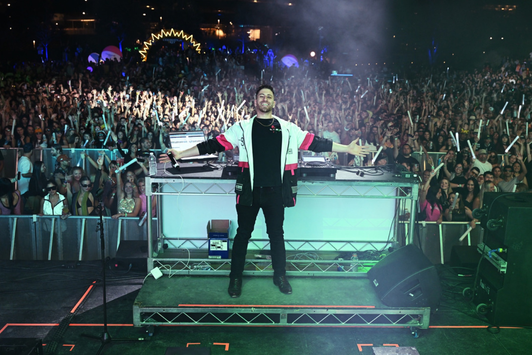 Jordan Miller on stage at SXSW with arms raised in front of a packed crowd