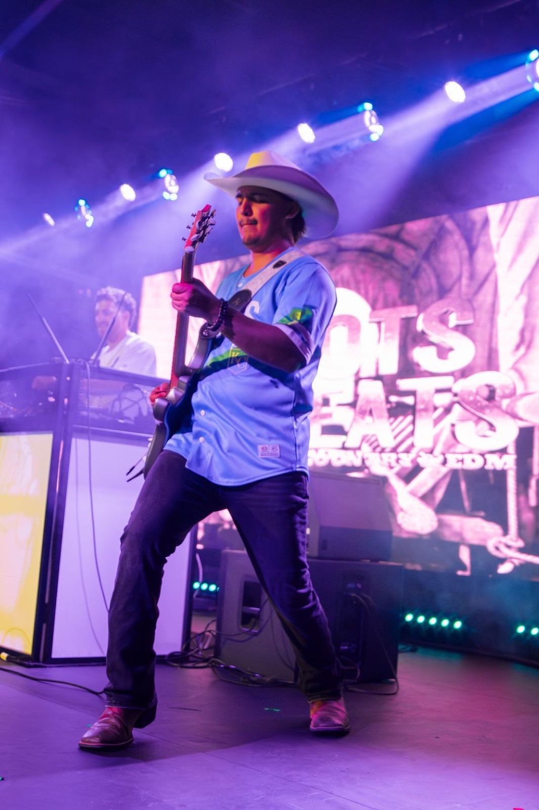 Kristian Cruz on guitar in front of the LED wall at Warehouse on Broadway, Kansas City