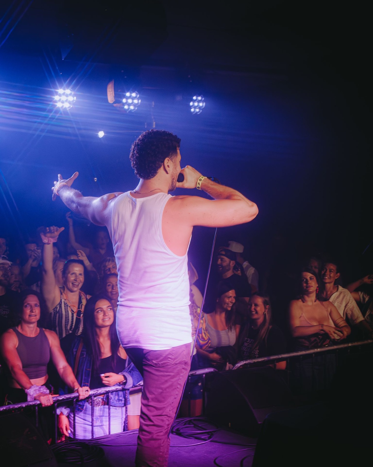 Jordan Miller with arms out over the crowd at The Get Down, Portland
