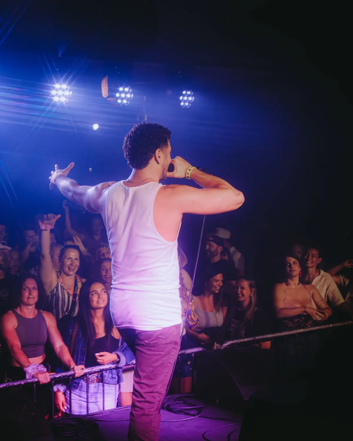 Jordan Miller with arms out over the crowd at The Get Down, Portland