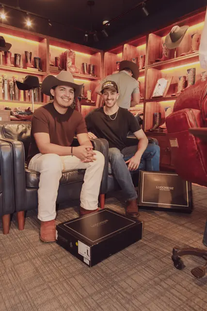Jordan Miller and Kristian Cruz seated inside the Lucchese store