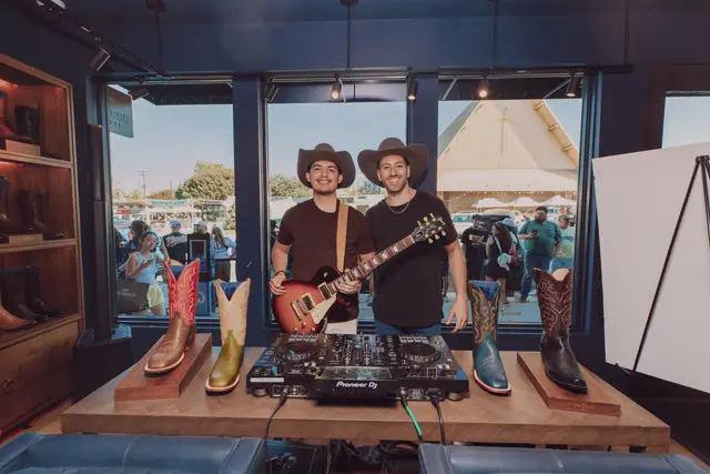 Jordan Miller and Kristian Cruz at the DJ setup by the Lucchese window