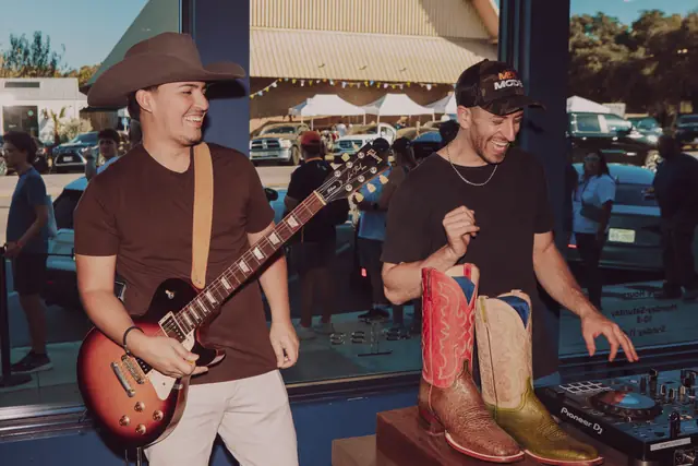Kristian Cruz on guitar beside Jordan Miller at the decks, Lucchese pop-up