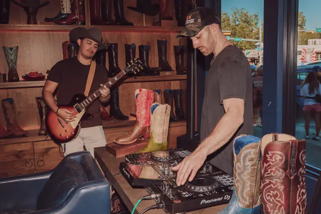 Kristian Cruz on guitar while Jordan Miller DJs at Lucchese