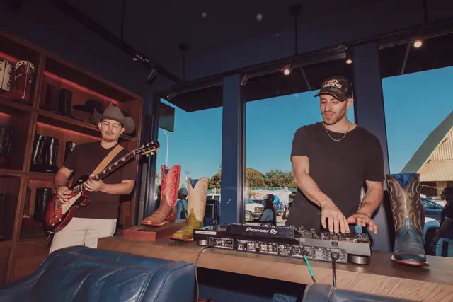 Kristian Cruz and Jordan Miller performing by the Lucchese storefront windows