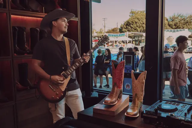 Kristian Cruz playing live guitar at the Lucchese F1 Weekend pop-up