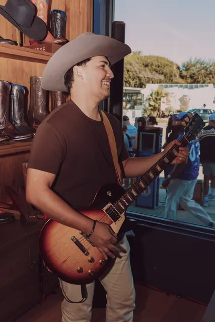 Kristian Cruz playing live guitar at the Lucchese F1 Weekend pop-up