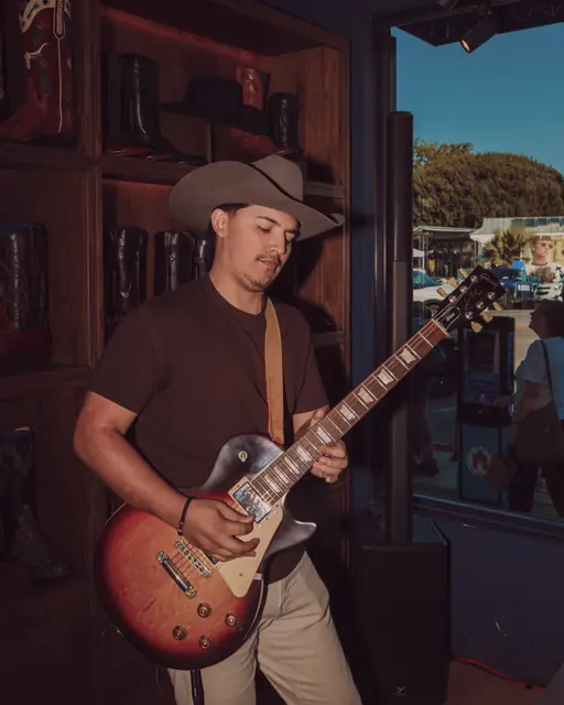 Kristian Cruz playing live guitar at the Lucchese F1 Weekend pop-up