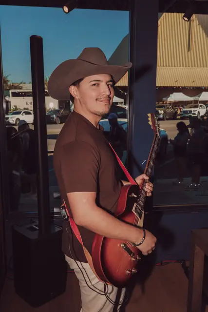 Kristian Cruz playing live guitar at the Lucchese F1 Weekend pop-up