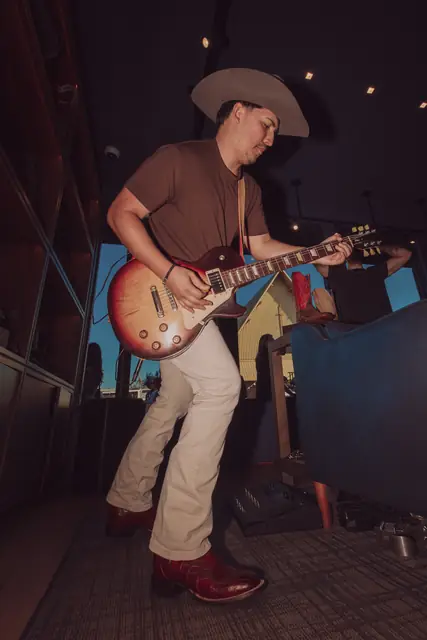Kristian Cruz playing live guitar at the Lucchese F1 Weekend pop-up