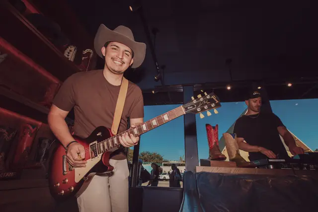 Kristian Cruz playing live guitar at the Lucchese F1 Weekend pop-up