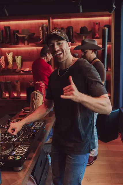 Jordan Miller DJing at the Lucchese F1 Weekend pop-up