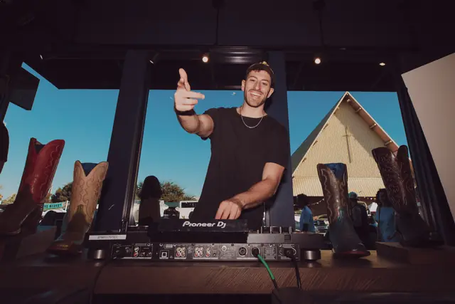 Jordan Miller DJing at the Lucchese F1 Weekend pop-up